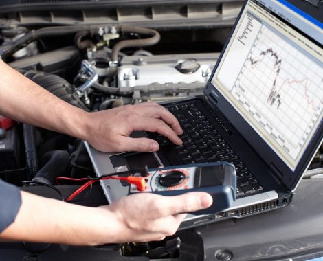 Professional car mechanic working in auto repair service.